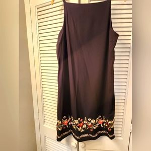 Black dress with floral embroidered detailing at the hem